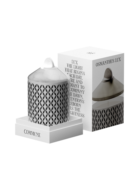 A white Osmanthus Lux candle with a geometric pattern, in an aluminum container with a white onyx  lid.