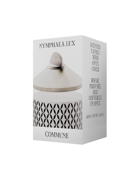 A white Nymphea Lux candle with a geometric pattern, in an aluminum container with a white onyx lid in a box.