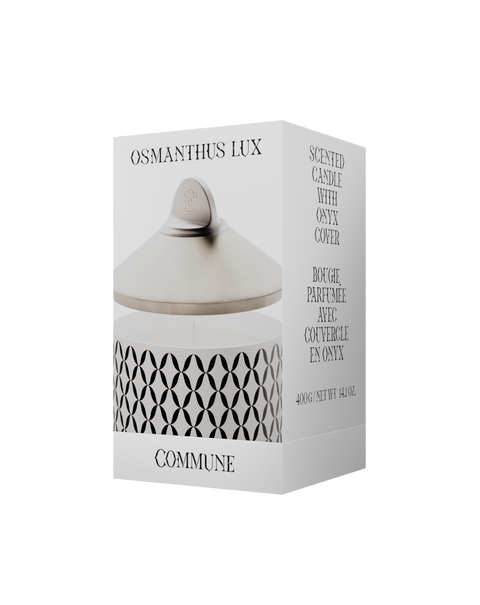 A white Osmanthus Lux candle with a geometric pattern, in an aluminum container with a white onyx  lid.