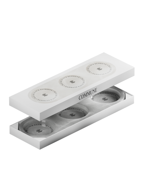 A circular white onyx triple tray with a product label in the center in box.