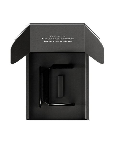 A wall bracket designed for mounting a 500ml Commune bottle