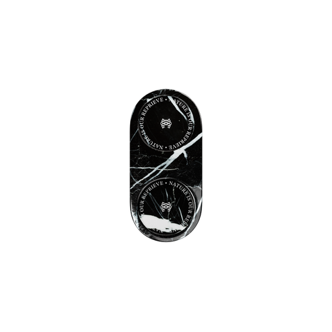 A black oval-shaped black marble tray