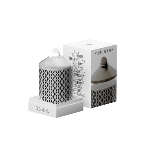 A white Nymphea Lux candle with a geometric pattern, in an aluminum container with a white onyx lid in a box.