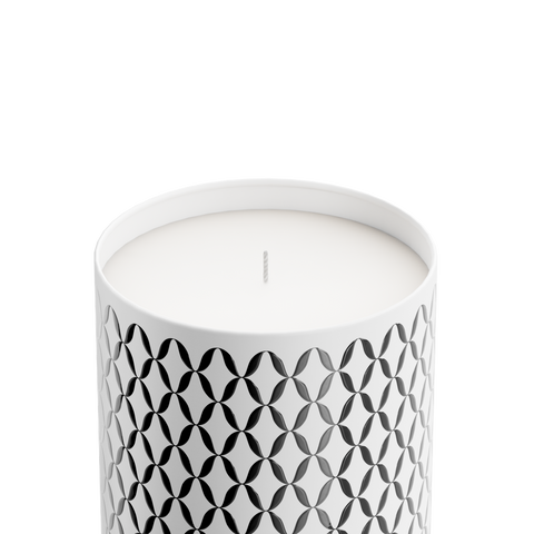 A white Osmanthus Lux candle with a geometric pattern, in an aluminum container with a white onyx  lid.