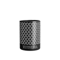 A luxury scented Vetiveria Nox candle with a geometric pattern on its aluminum vessel.