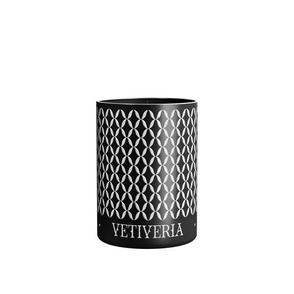 A luxury scented Vetiveria Nox candle with a geometric pattern on its aluminum vessel.