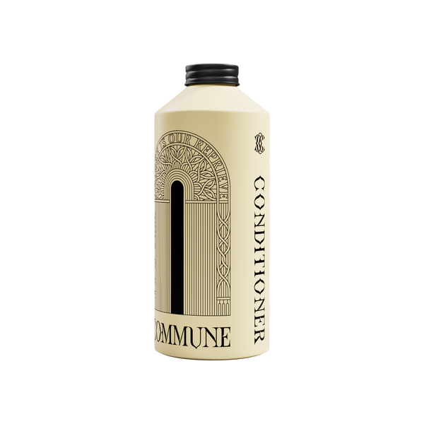 A cream-colored bottle of Commune hair Conditioner with a black cap, featuring a black Art Deco arch graphic on the front.